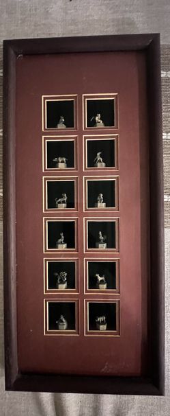Zodiac-themed display frame with figurines