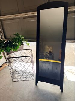 Mirror, laundry basket and plant