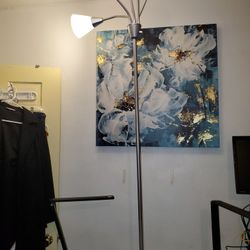 5-bulb floor lamp. This lamp has adjustable gooseneck arms, allowing you to direct the light where needed. It has a modern design and is  in white,  b