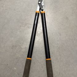 Fiskars Power-Lever Bypass Lopper, a type of gardening tool used for trimming branches.