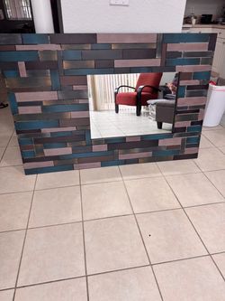 metal multi block mirror. 59”X39”. The mirror is 27 1/2”X19”. Used in good condition.