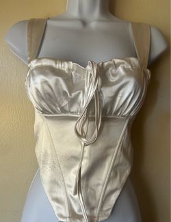 Women's white satin corset-style top with front lacing, size XS.