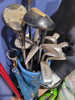 Golf clubs with bag and wheeled carrier