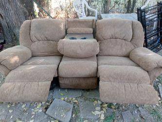Couch with dual recliners and table in middle