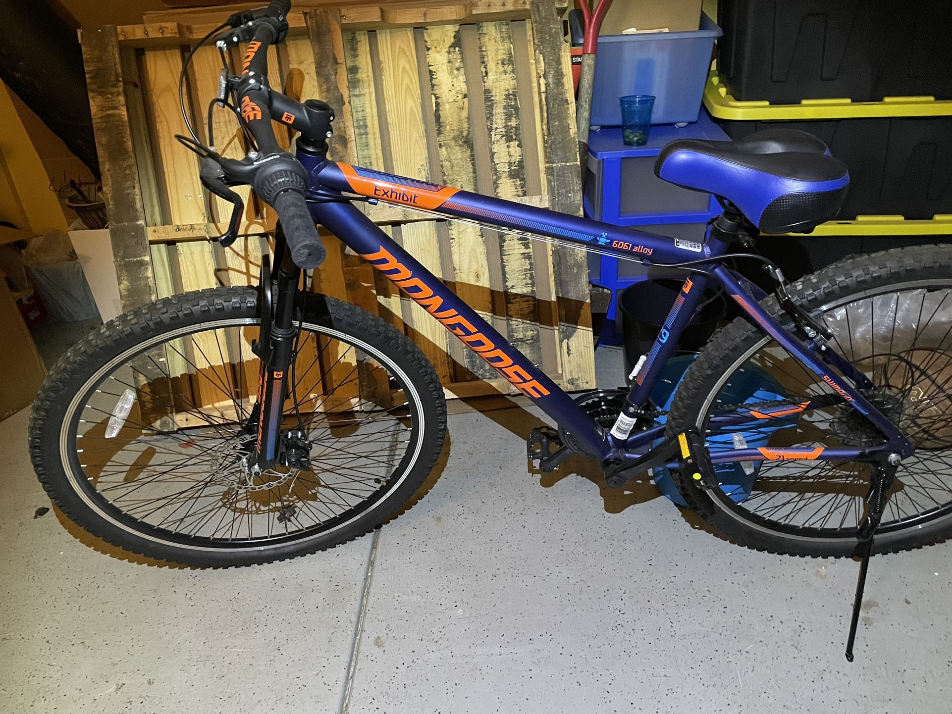 Mongoose Exhibit Mountain Bike, 29-inch wheels, 21 speeds, blue