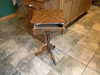 This vintage wooden accent table features a distinctive parquet top pattern set upon a classic carved tripod pedestal base.  Approximately 26” tall an