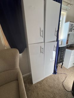 2 tall storage cabinets