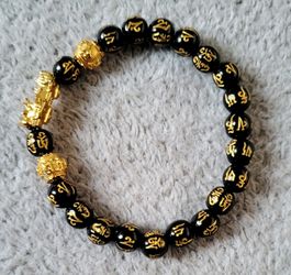 Feng Shui Pixiu Black Obsidian Bracelet, a popular spiritual accessory often used as an amulet to attract wealth and good fortune.