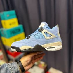 Jordan Air Jordan 4 "University Blue" Lightweight, woven upper, mid-top, retro basketball shoes for men, in university blue color.