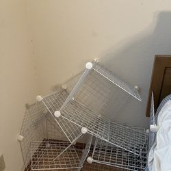 white metal cube storage rack that needs to be assembled 