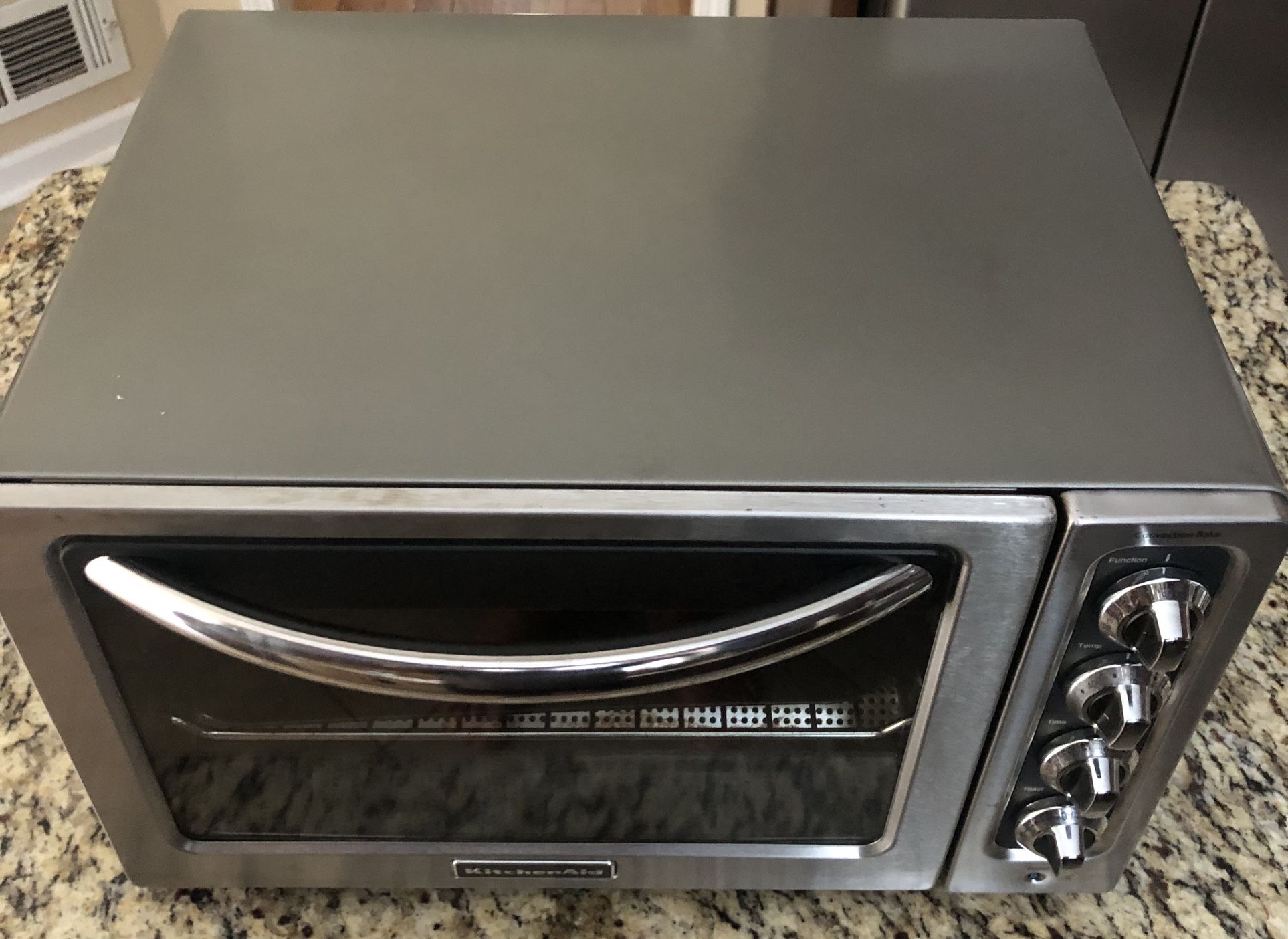 The KitchenAid KC02230J, iKitchenAid 12 Inch Compact Convection Bake Countertop Oven, features a convection function
