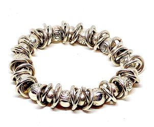 Silver tone bracelet made of slide in charms