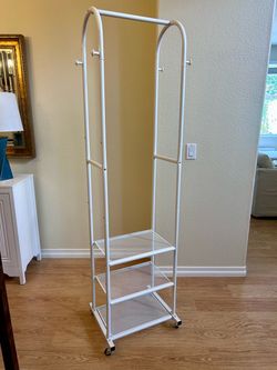 White clothes rack hanging closet with 3 shelves