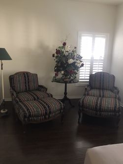 Two matching chair with ottoman and decorative table and lamp (floral not included)