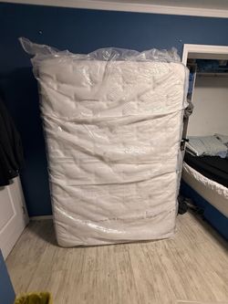 New full-size bed with extra topper