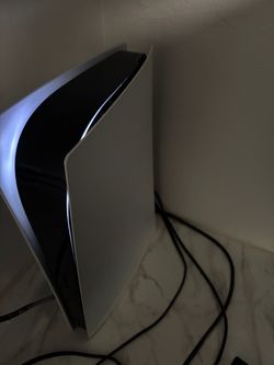 playstation 5 with cords and controller
