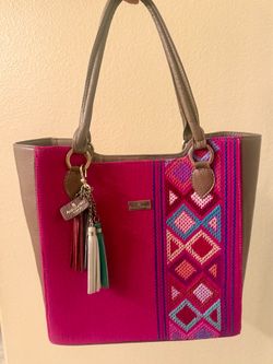 Leather bag with hand-embroidered fabric