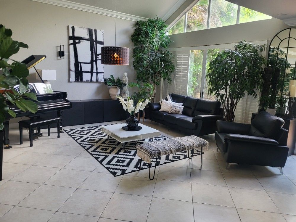 Black Leather Couch and Chair. White Coffee Table.  