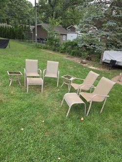 4 outdoor chairs with end tables and ottomans