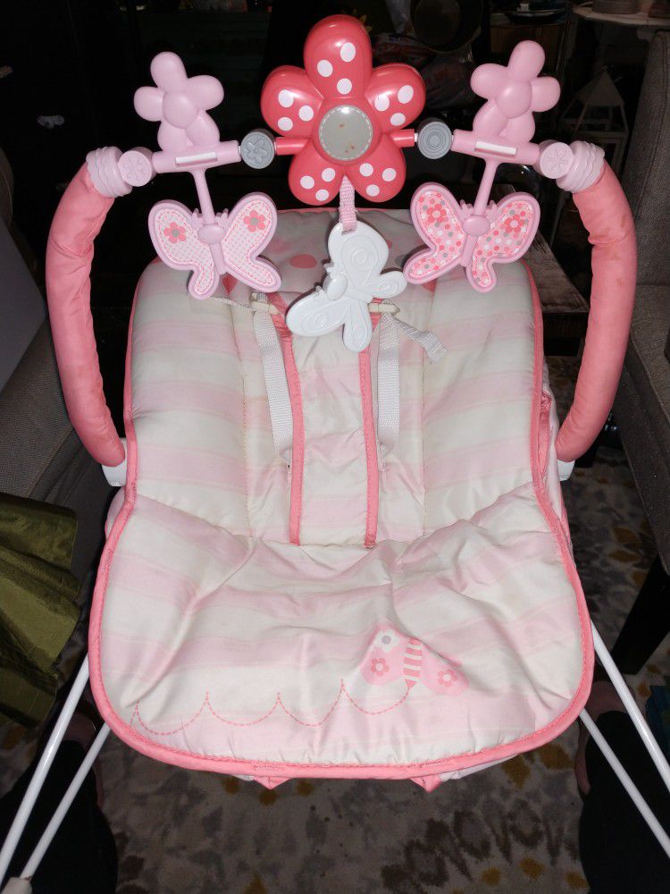 Baby Girls sitting playmate with buckle. Doesn't vibrate but you can bounce. Activity butterflies are removable.