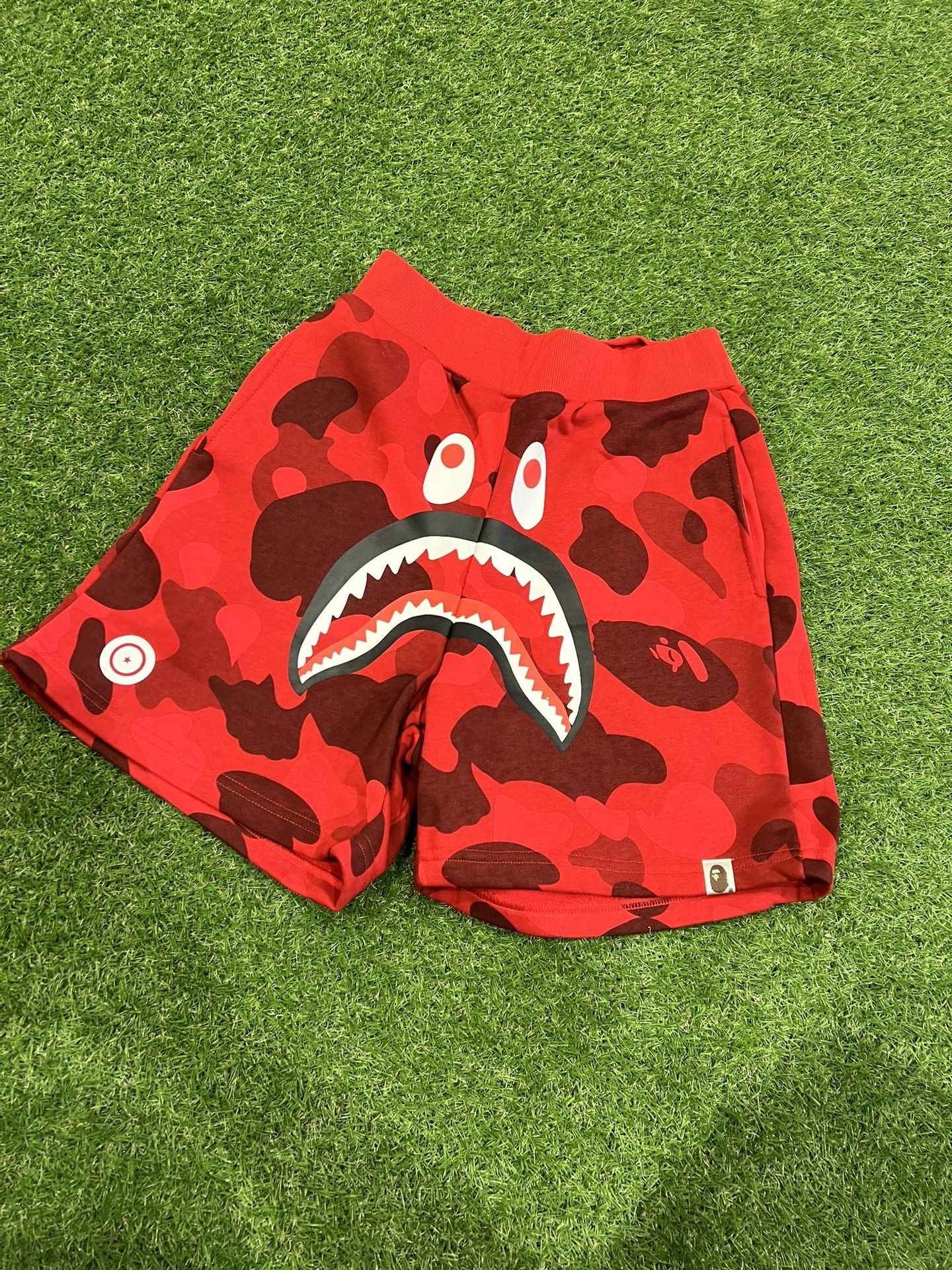 bape - red camo sweat shorts