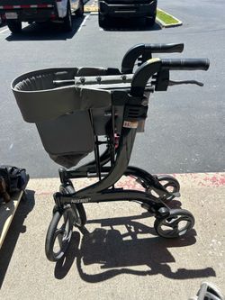 Drive Medical rollator walker features a grey removable carry pouch and a lightweight folding frame