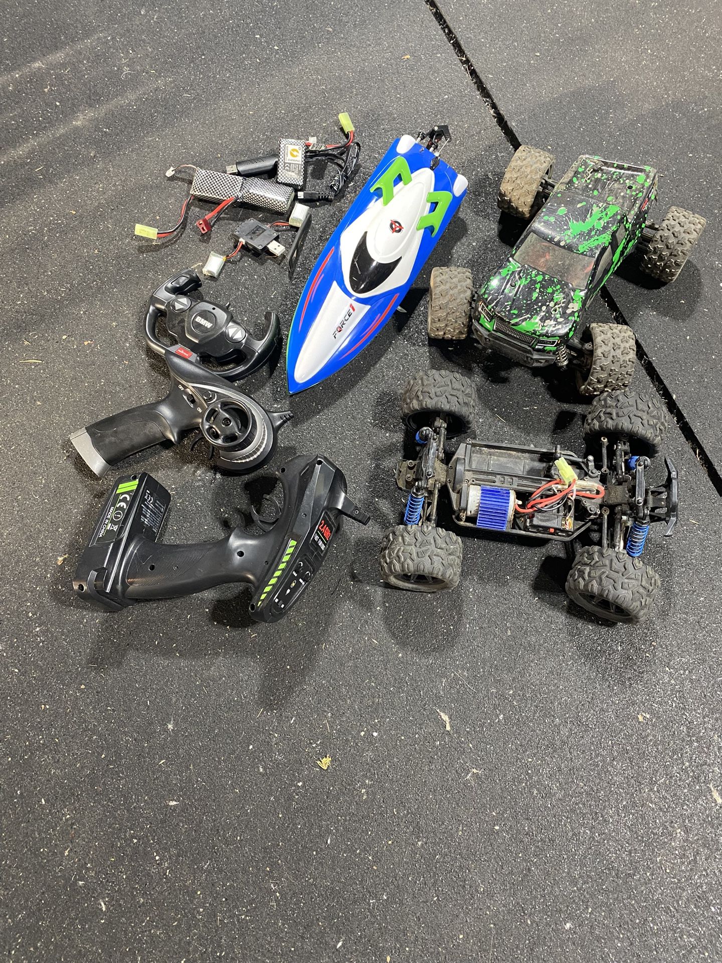 RC Cars & Boat Lot – Includes 2 Trucks, 1 Speed Boat, 2 Controllers, and Batteries
