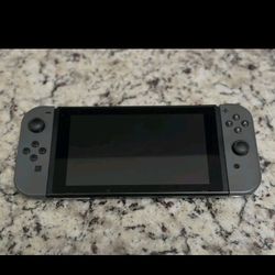 Nintendo Switch 1 (model HAC-001) in Black and Grey.
