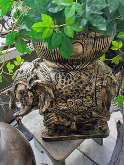Really nice heavy elephant plant stand with artificial plant included