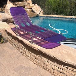 Vintage Tri-Folding neon blue & purple vinyl Tube Shell Pattern Beach Chair. Chair measures 10” from ground to the seat. Center 22” Wide.