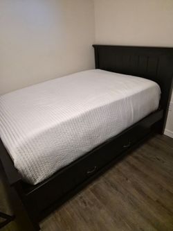 Full sized black wood bedframe with trundle mattress included