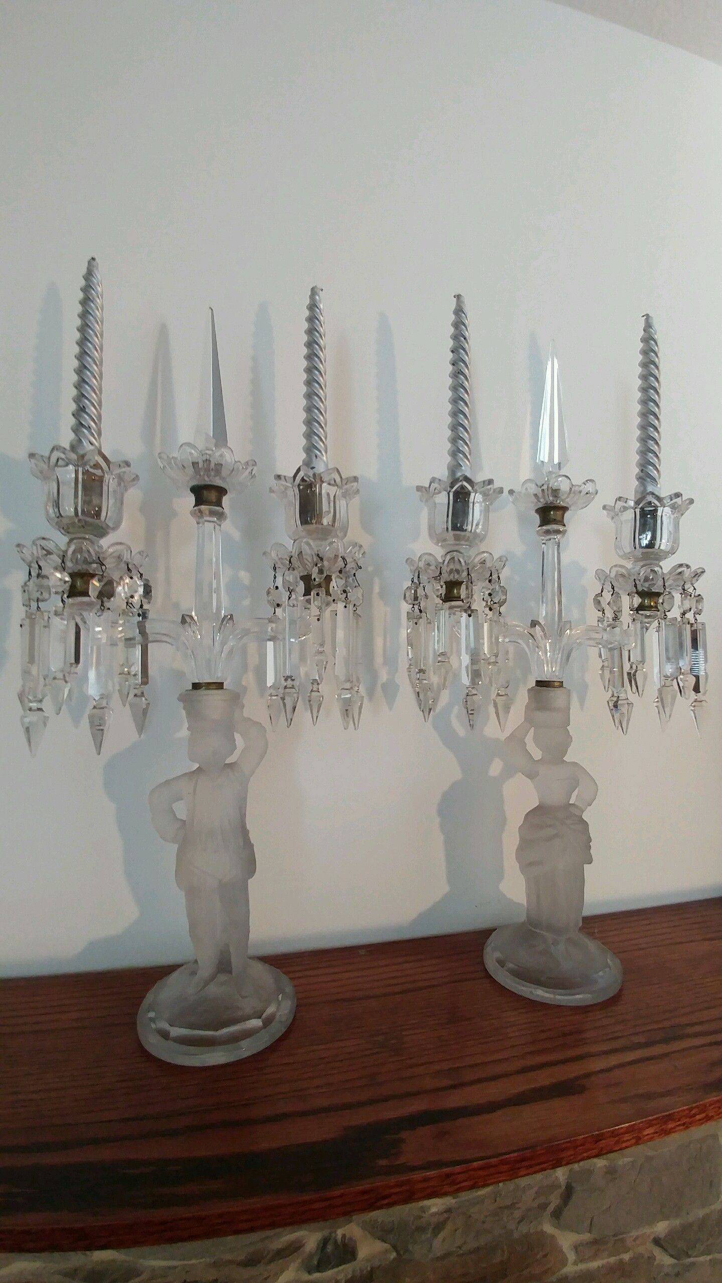 Large early Baccarat man and woman candelabras with prisms rare