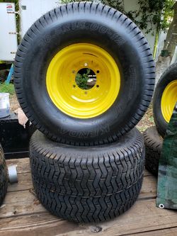 Pair of 26.5x14.00-12 Kenda K507 Turf Lawnmower Tires on a JD yellow 6-lug wheel