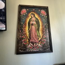 This item is a framed print of Our Lady of Guadalupe, featuring a handcrafted rustic wood fram