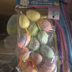 Greenbrier International Foam Easter Egg Ornaments featuring multicolored glitter and hanging loops. 