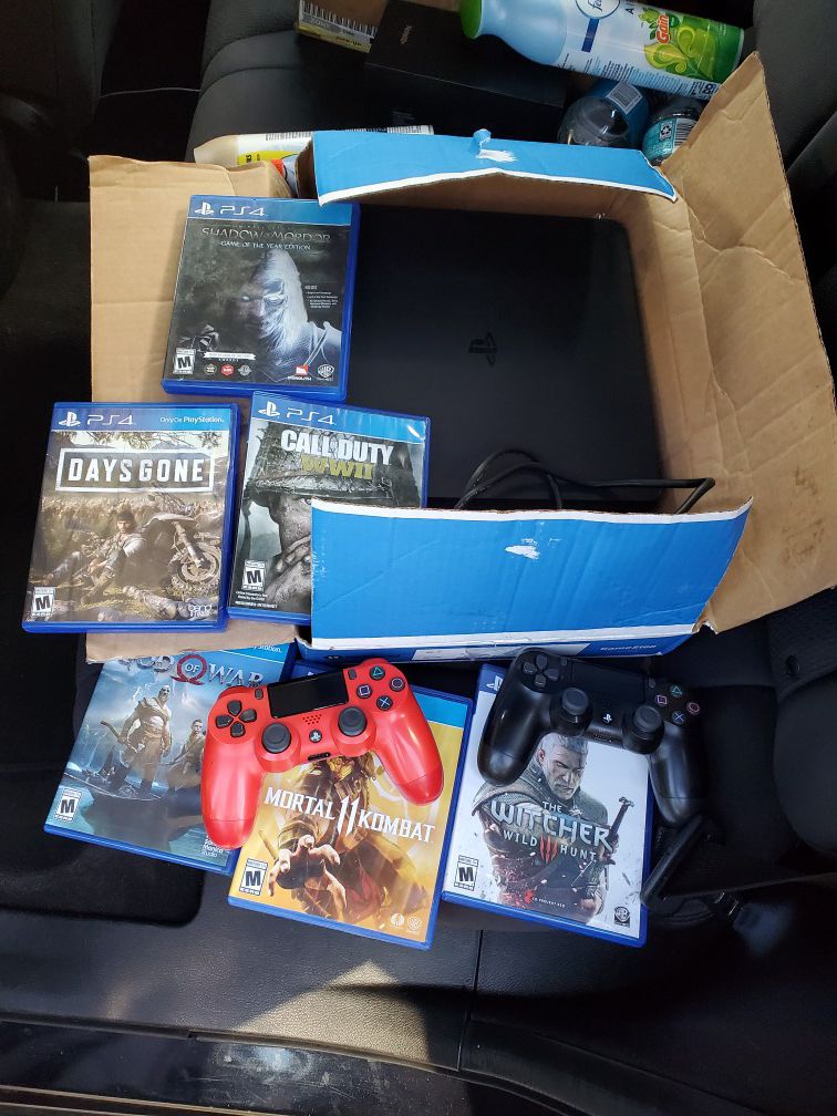 Playstation 4 with 2 remotes and a few games 1Tb memory