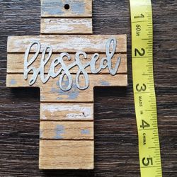 Rustic-style wooden cross with a metal "blessed" embellishment, wall decor. 