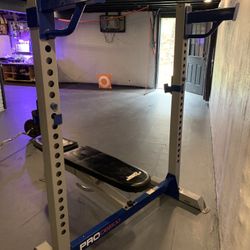 Weight Bench With Bar And Misc Weights. 