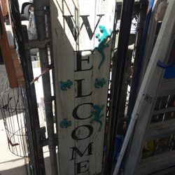 Old Welcome Sign With Metal Little Decorations