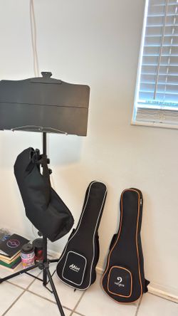 Musical instruments 2 ukuleles and 1 foldable music stand