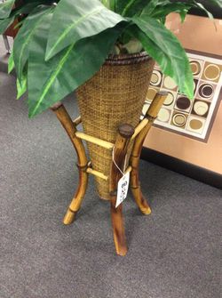 Rattan plant holder with tropical plant
