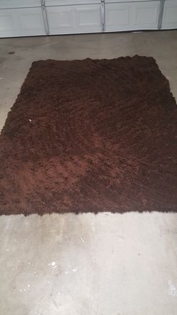 A brown shaggy area rug