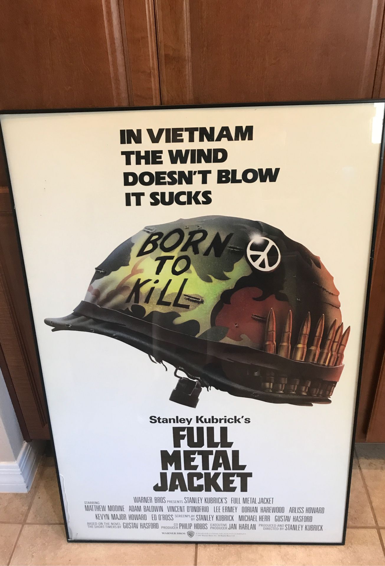 Full metal jacket framed behind glass movie poster