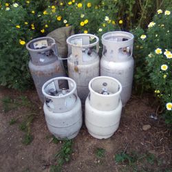 Three Forklift Propane Tanks And Two Smaller Industrial  Propane Fuel Tanks