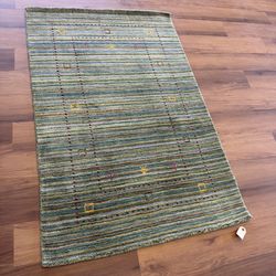 Green handmade wool gabbeh rug