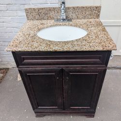 Bathroom 24 Inch  Cherry Stained Vanity . Moen Faucet. Granite Countertop
