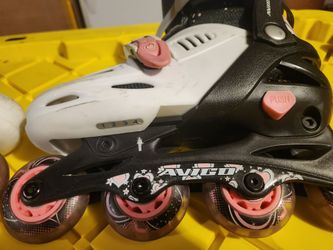 Pink white and black rollerblades