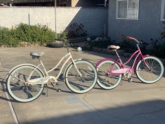 TWO WOMEN BEACH CRUISERS