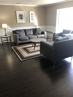 Ashley couch two chairs throw rug cocktail table used for staging