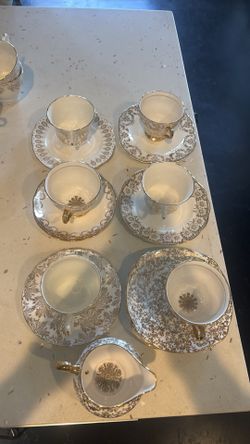 White and gold tea cups and plates imported from England
